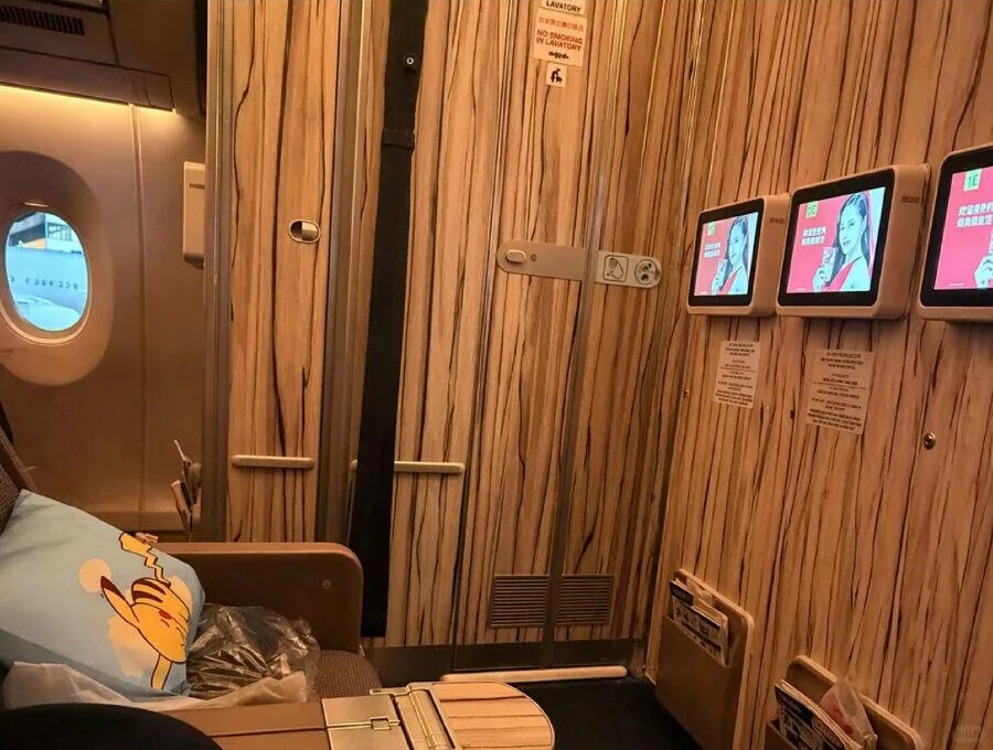 China Airlines A350 premium-economy cabin with persimmon wood-grain finish