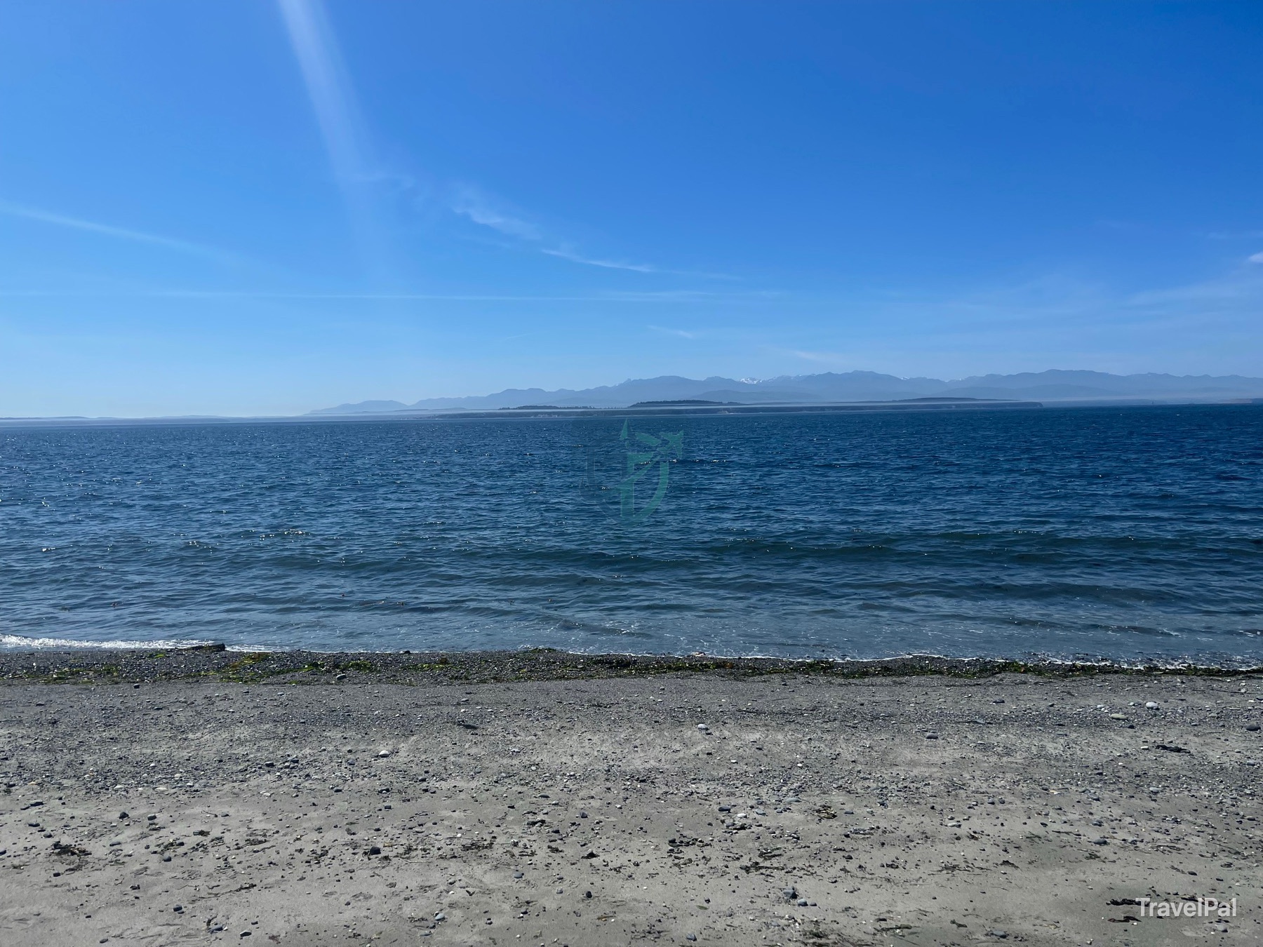 Open Puget Sound and distant mountain ranges seen from the shore at Ebey’s Landing