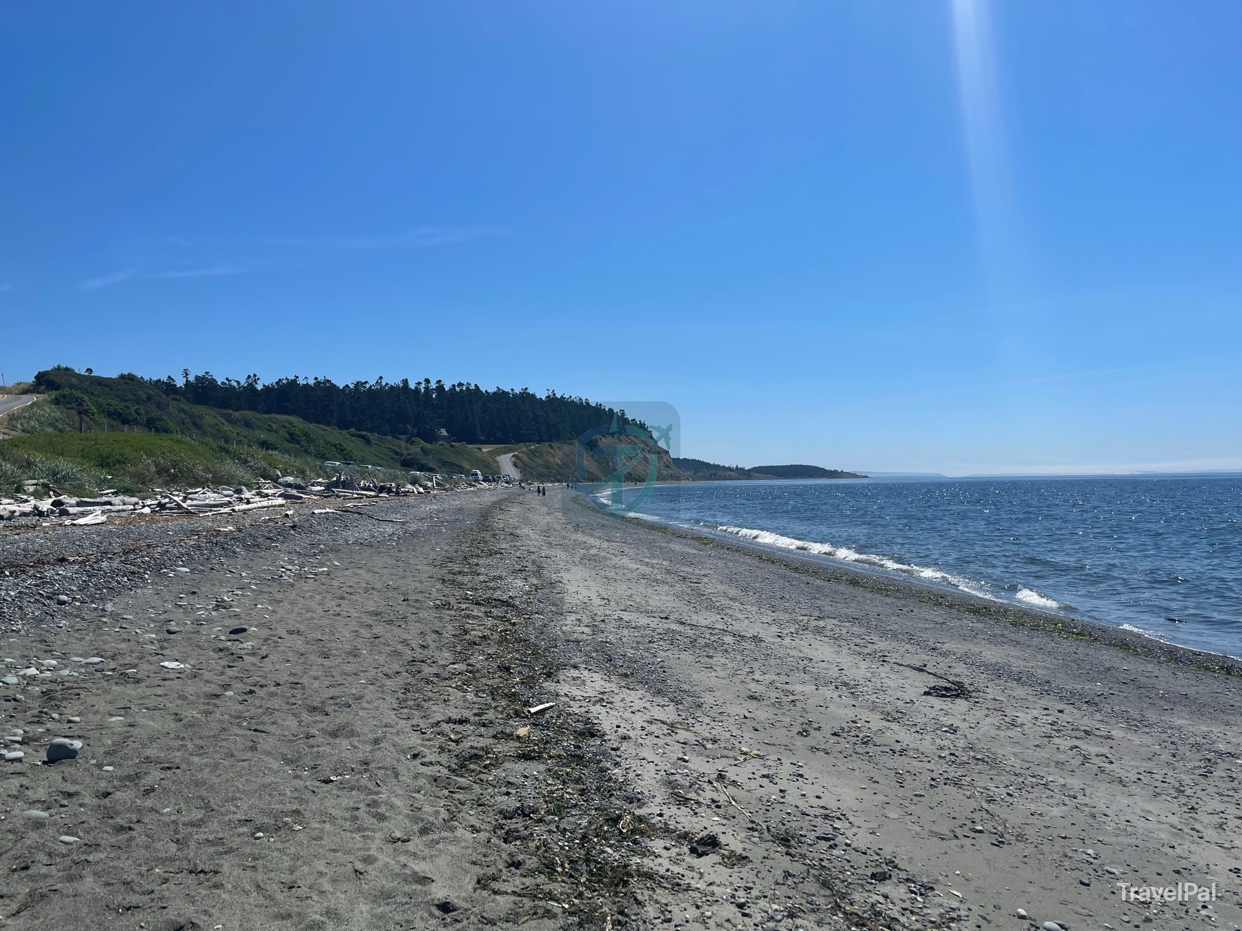 Pebble and sand beach curving beneath the bluff at Ebey’s Landing on Whidbey Island