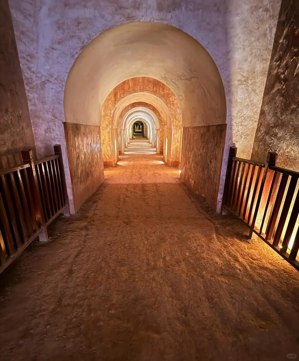 Long illuminated vaulted passage descending through Princess Yongtai's tomb at Qianling