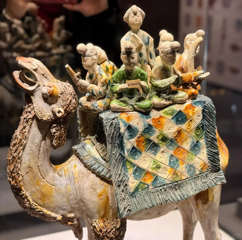 Tang sancai-glazed camel carrying a group of musicians and a singer