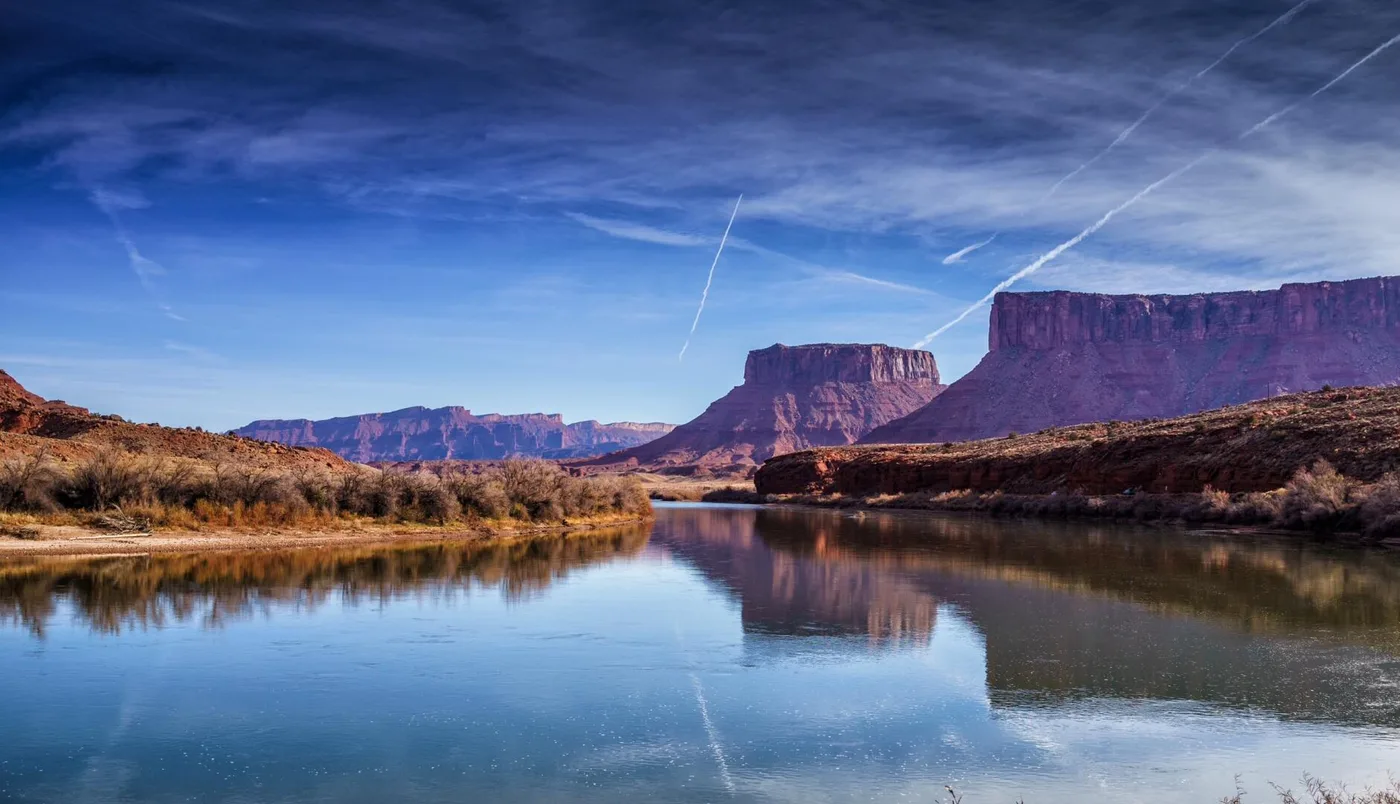 Still water reflecting desert cliffs in Utah